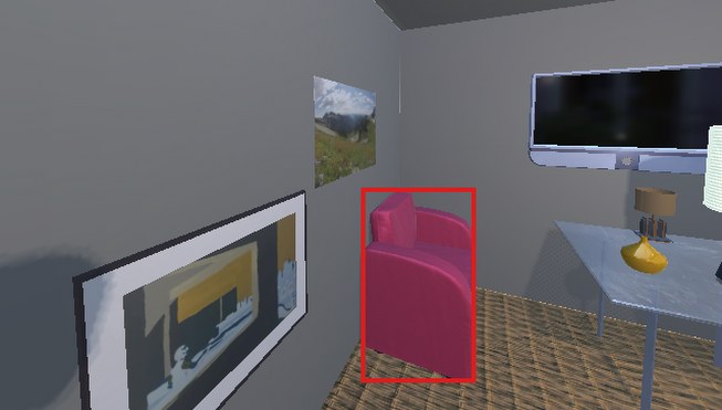 First view of a grey-walled lounge. A pink armchair is marked with a red box, beside a framed picture and a television.